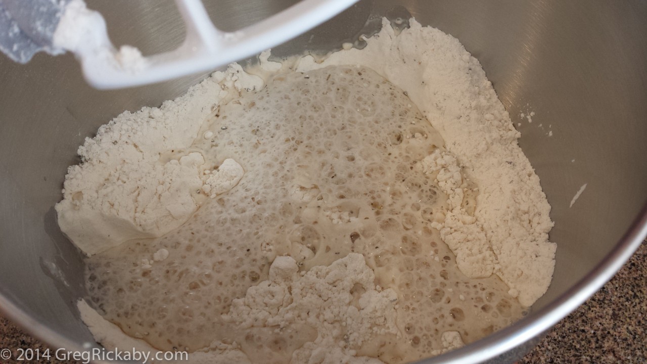 Once the yeast mixture has bloomed, add to flour.