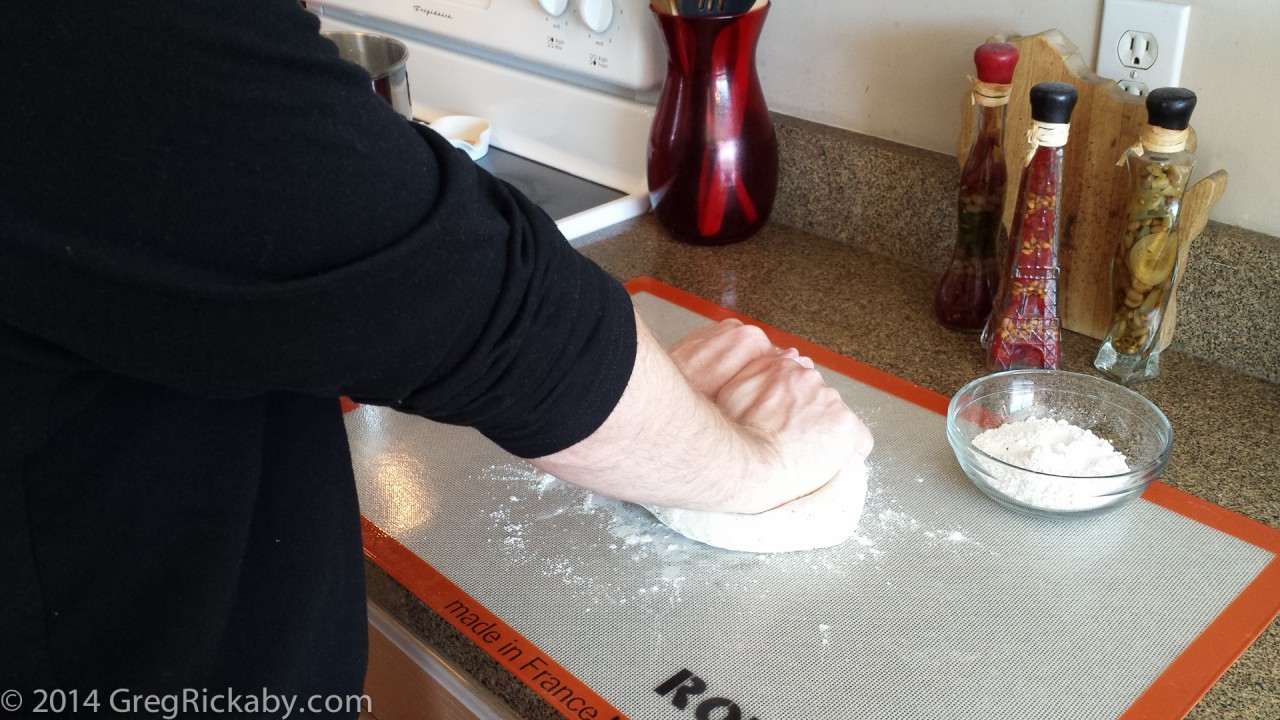 Using your palms, begin kneading the dough.