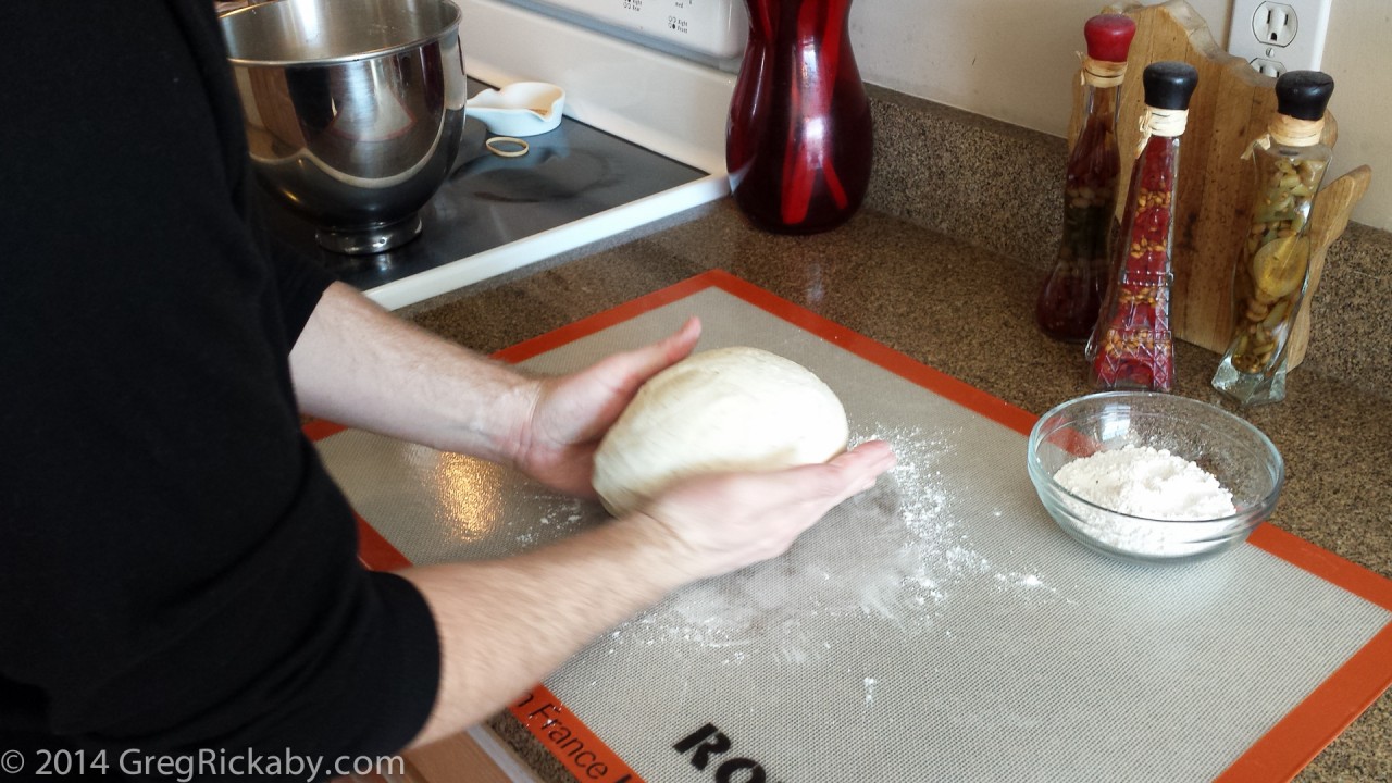 Cupping and spinning the dough until it forms a ball.