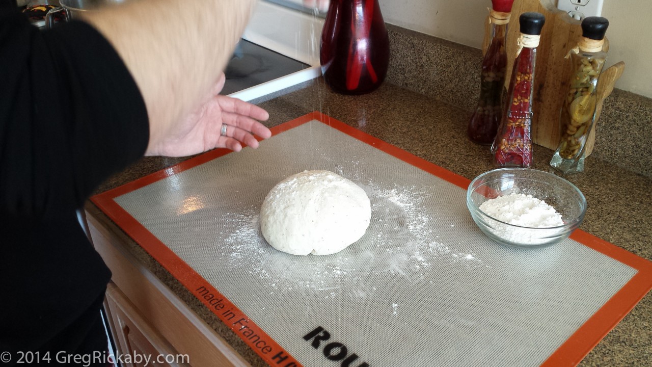 When you dough has been formed into a ball, sprinkle a little flour on top.