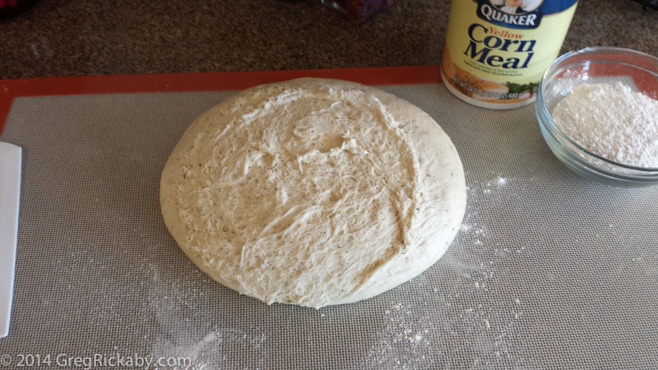 Remove the pizza dough from the bowl and place on a floured surface.