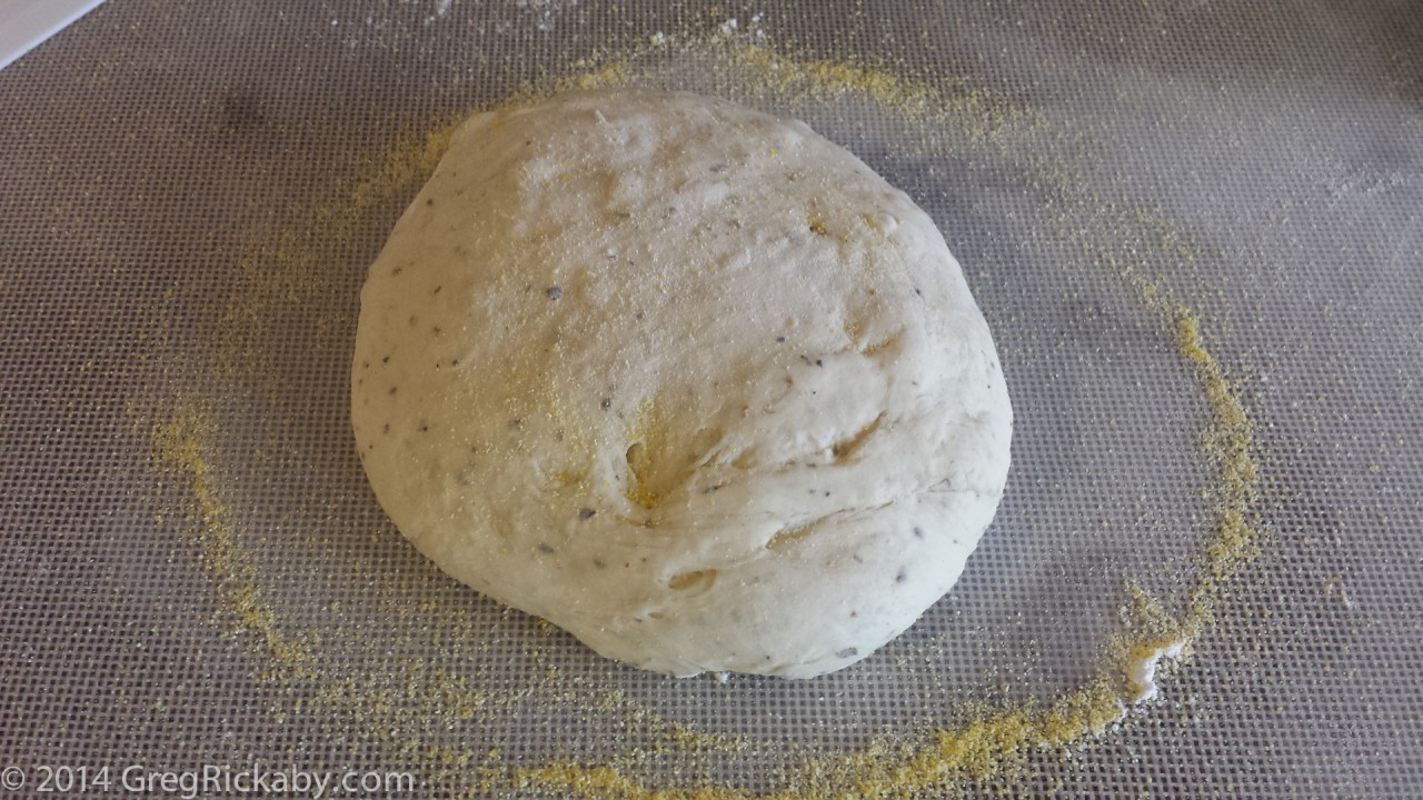 Cover both sides of the dough with the cornmeal and flour.