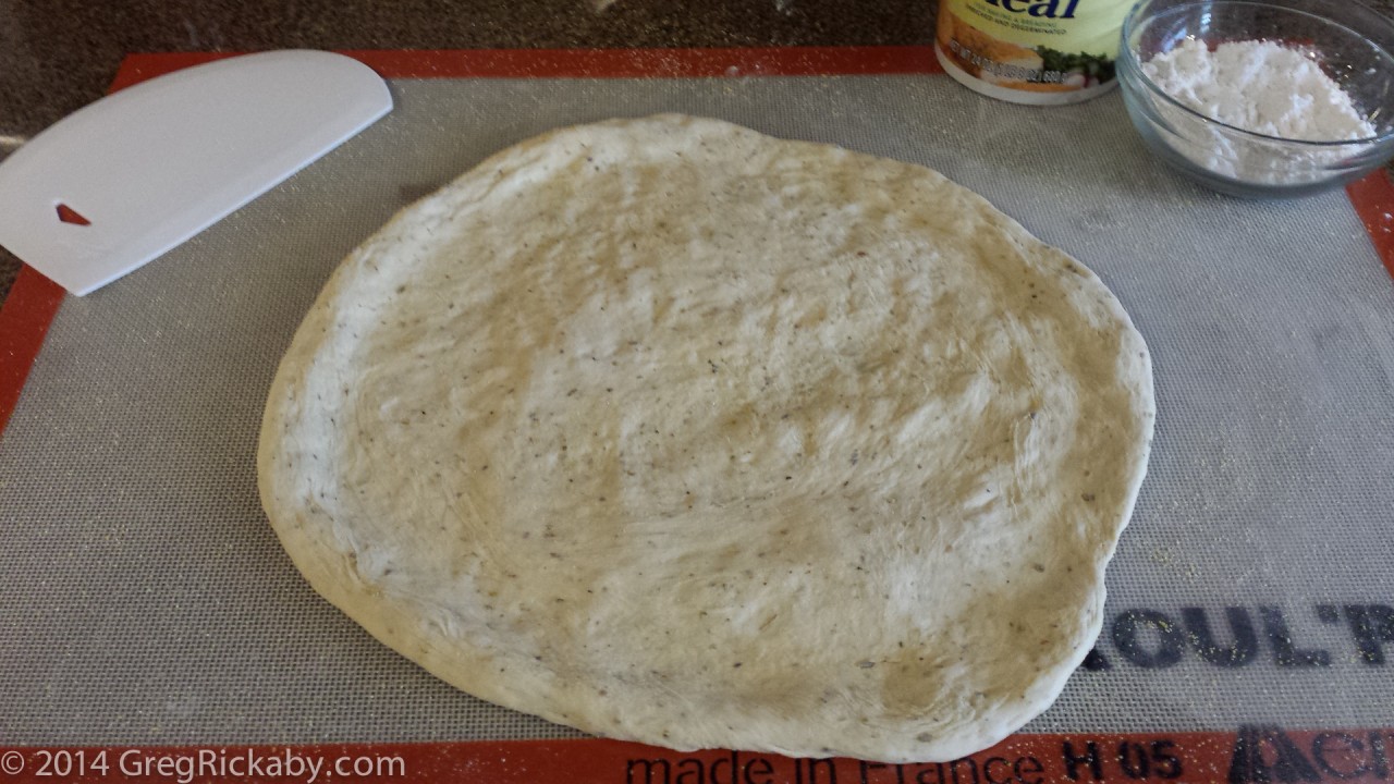 Using the push method, press the dough from the outside working in a circle. Toss the dough just about your head until it's big enough to cover a pizza peel or pan.
