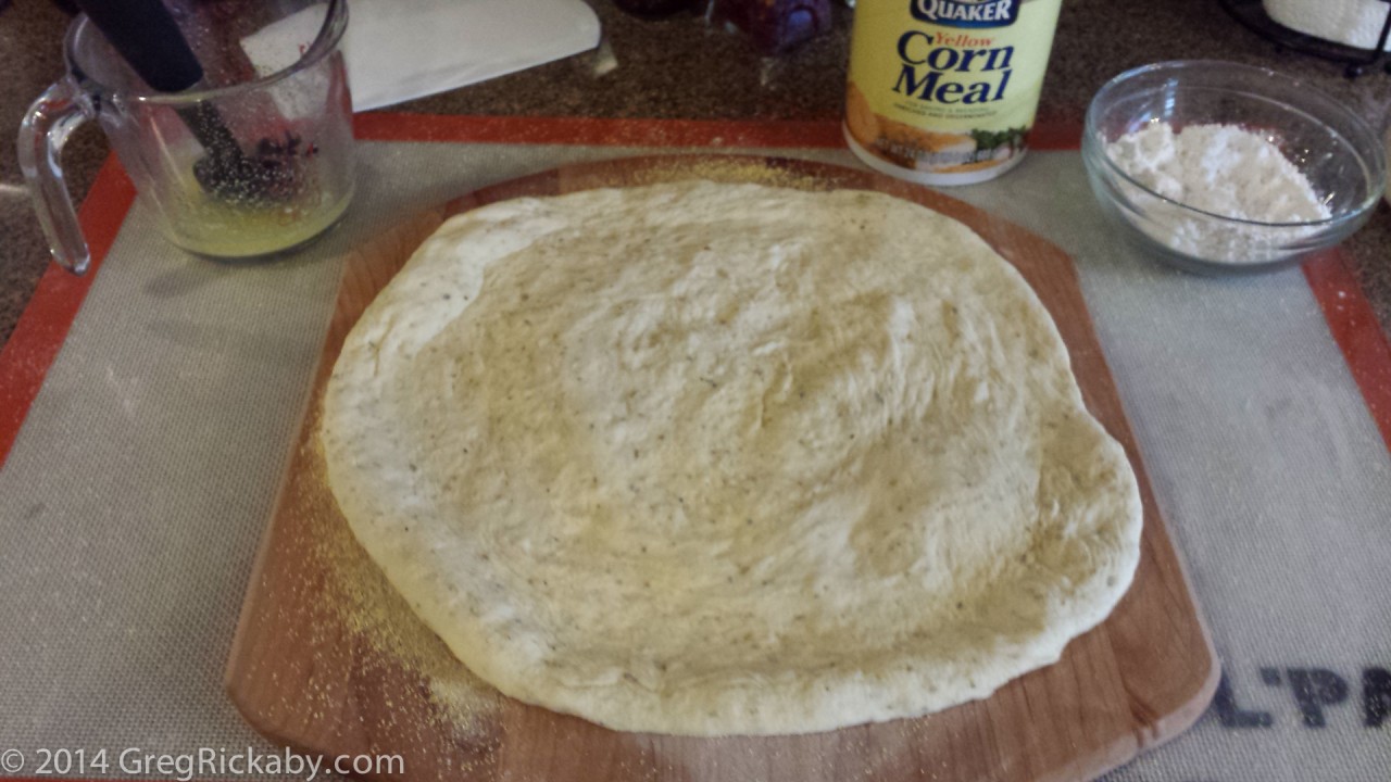 Place the dough on the peel. Melt some butter and add 1 tsp of garlic powder or garlic salt.