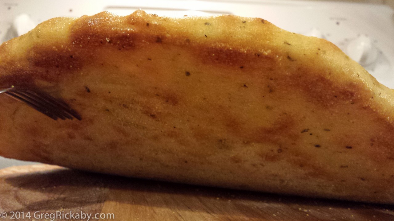 The bottom should be firm, crisp, and slightly dusted with cornmeal.