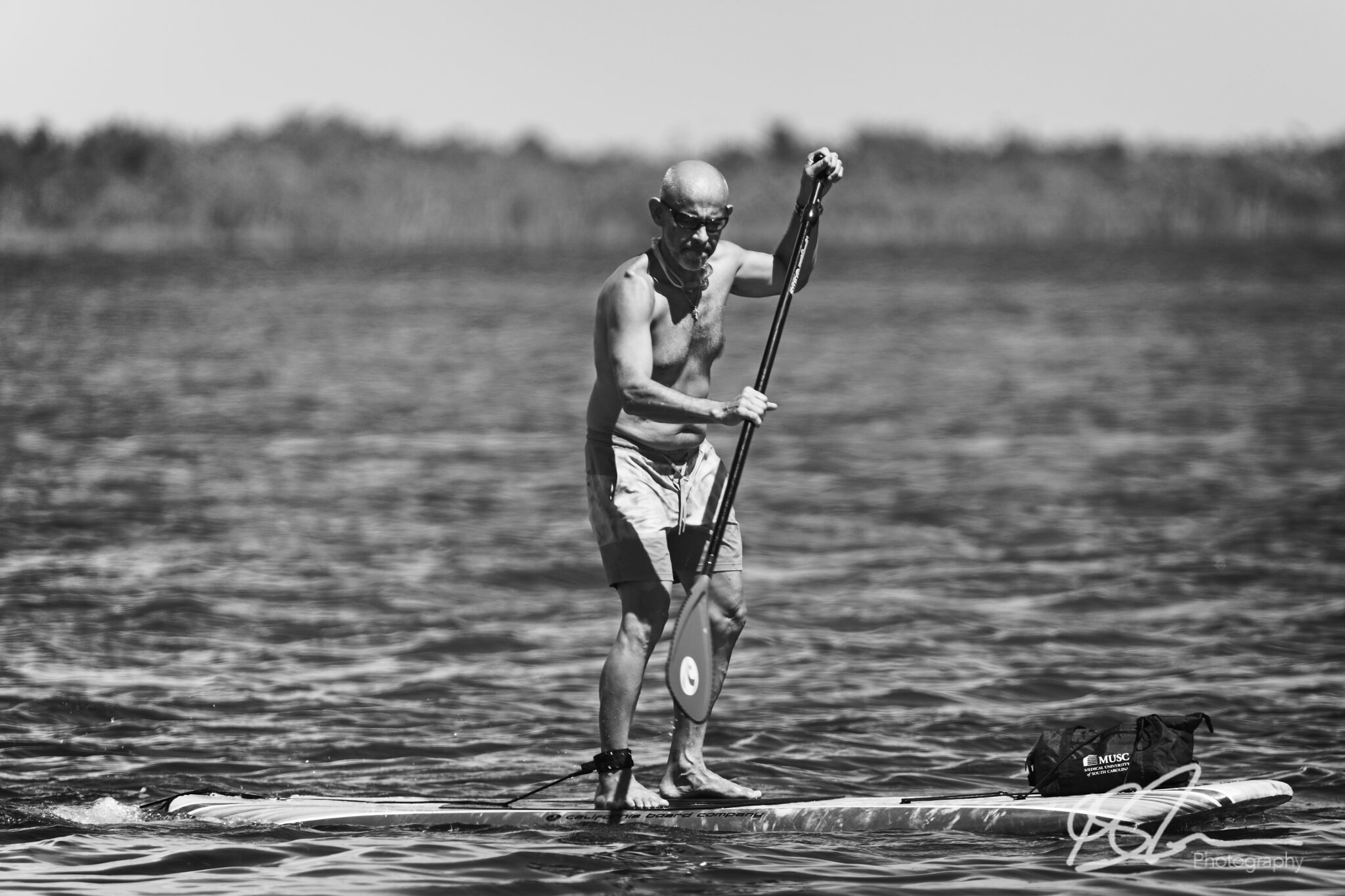 a man on a paddle-board off Alligator point in Panama City Florida
