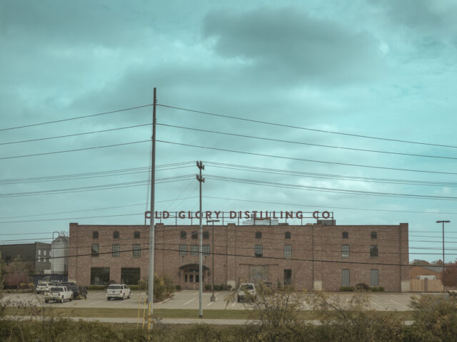 a large brick building with a sign that says old country distilling co on the top of it